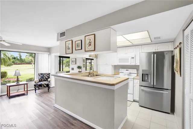 a kitchen with stainless steel appliances a sink and a refrigerator