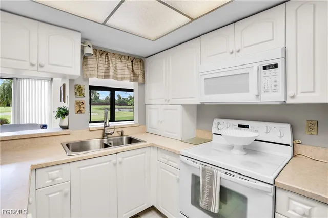 a kitchen with a sink cabinets and window