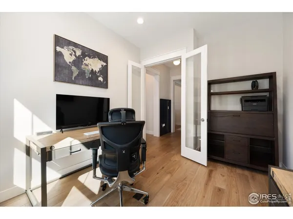 a view of a workspace with furniture and wooden floor