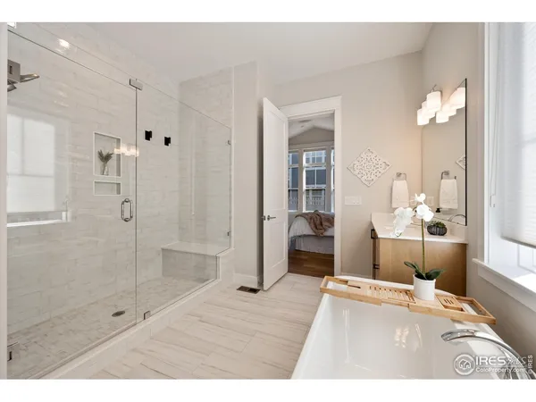 a bathroom with a shower sink and mirror