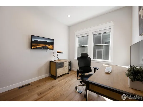a living room with furniture wooden floor and a flat screen tv
