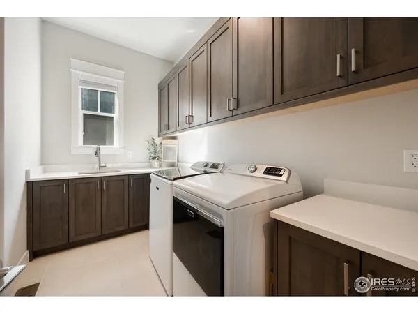 a utility room with sink dryer and washer
