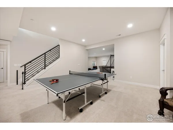 a room with furniture pool table and windows
