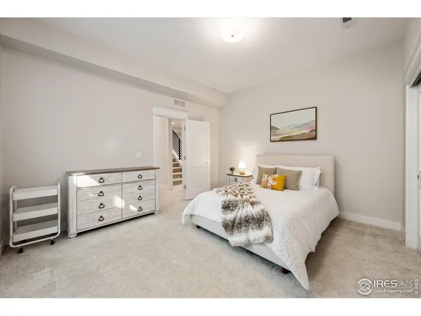 a bedroom with a bed and a night stand
