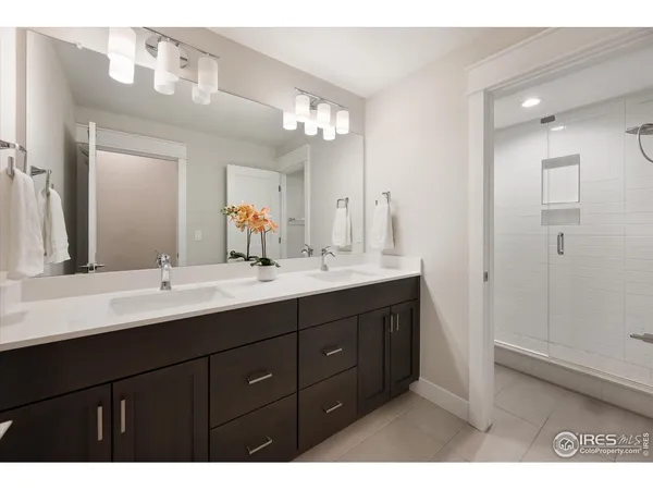 a bathroom with a double vanity sink and mirror