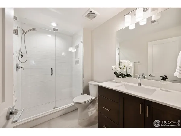 a bathroom with a sink shower and a mirror