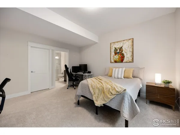 a bed room with a bed and a chair