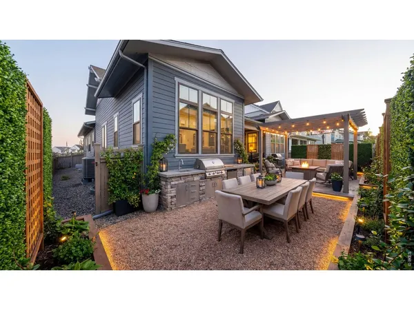 a backyard of a house with outdoor seating