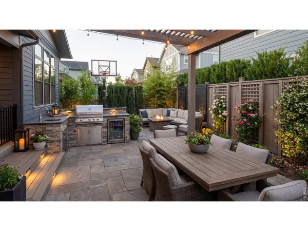 a backyard of a house with barbeque oven table and chairs