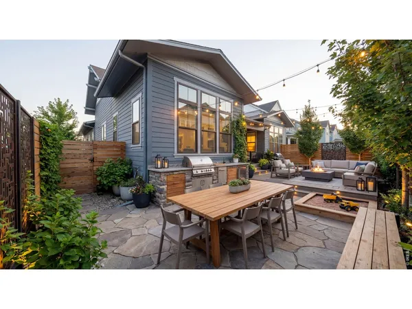 a backyard of a house with table and chairs