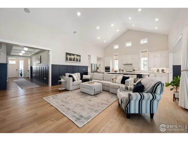 a living room with furniture and a dining area with kitchen view