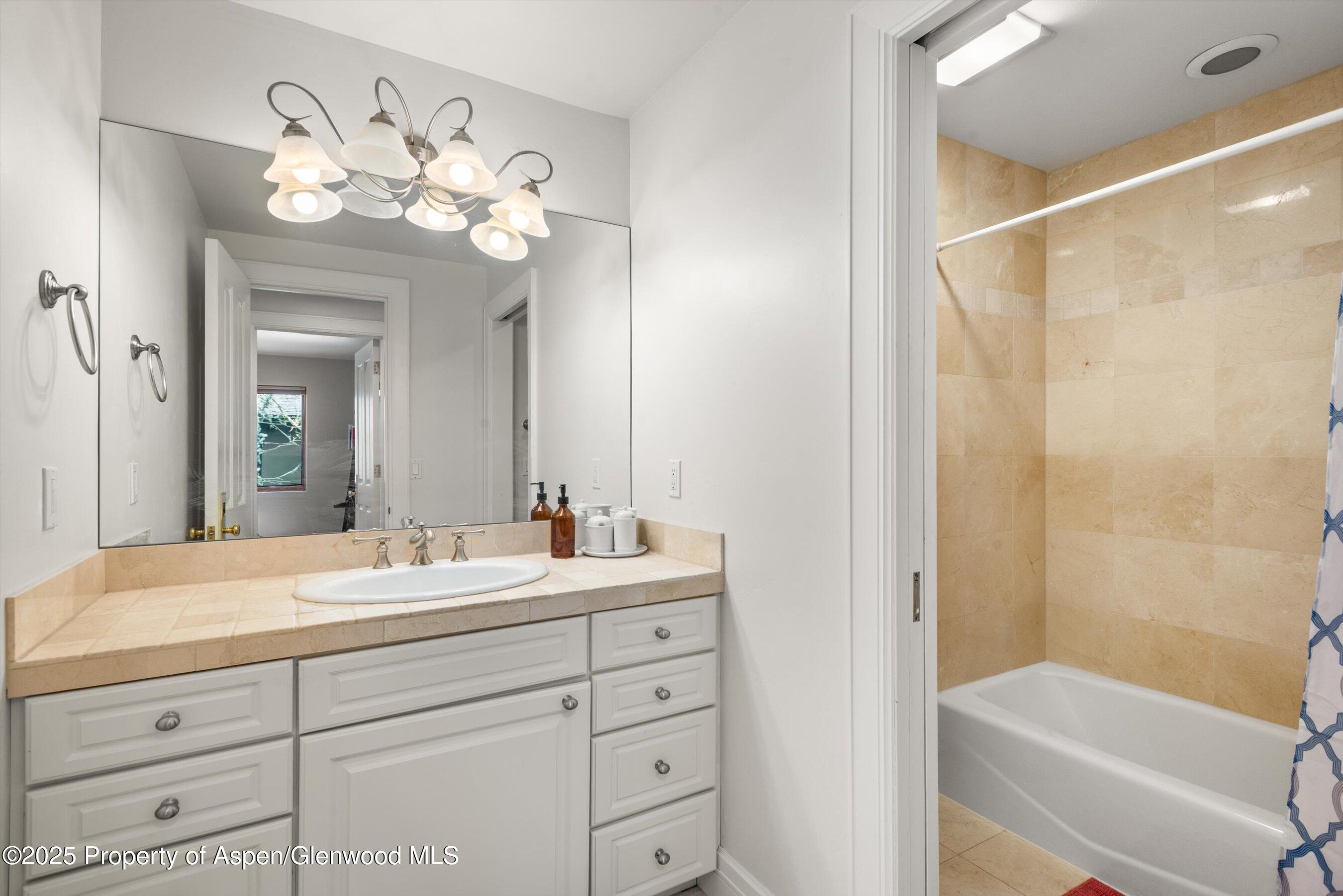 315 Summerset Lane, Unit A Basalt, CO 81621 - Photo 13 of 18 a bathroom with a double vanity sink mirror and a bathtub