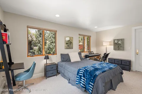 a bedroom with furniture and a large window