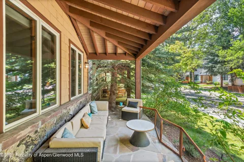 a view of a patio with chairs and a table