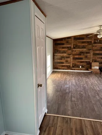 a view of a room with wooden floor and windows