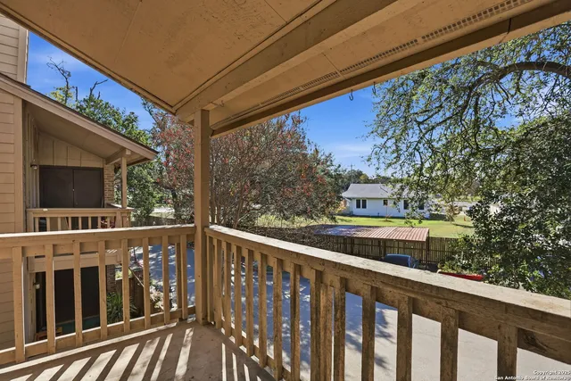 a view of a balcony with wooden floor