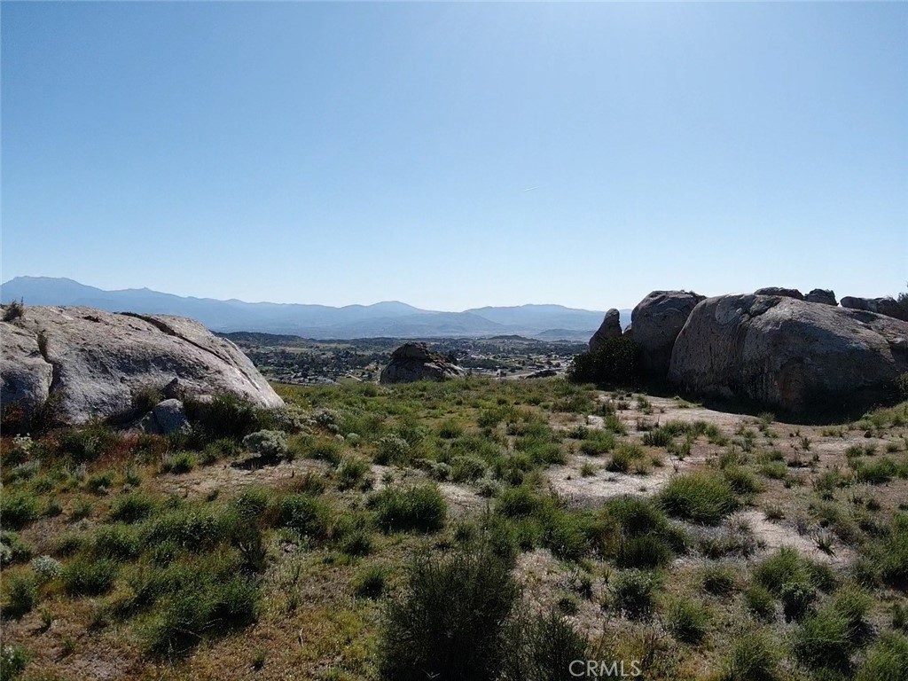 23698 Tapatia Road Homeland, CA 92548 - Photo 6 of 11 a large green field with some trees in the background