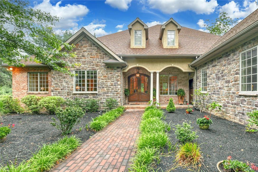a front view of a house with garden
