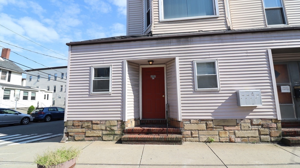 202 Washington Street, Unit 1F Somerville, MA 02143 - Photo 1 of 12 a front view of a house with stairs
