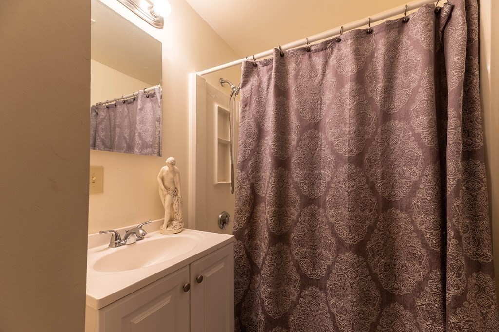 202 Washington Street, Unit 1F Somerville, MA 02143 - Photo 11 of 12 a bathroom with a sink and a mirror