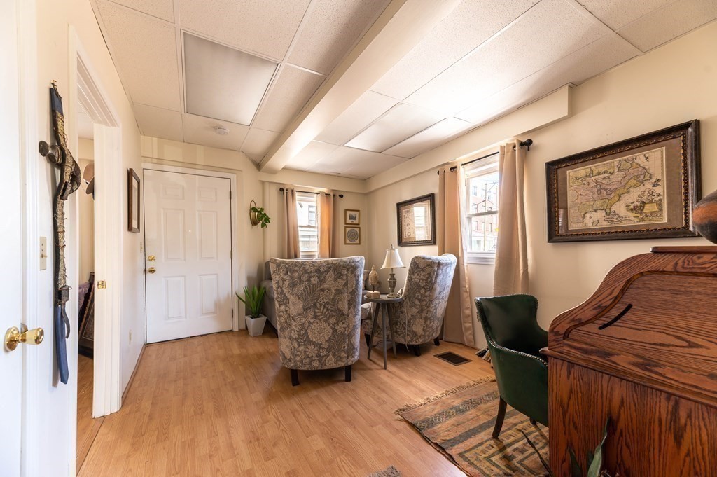 202 Washington Street, Unit 1F Somerville, MA 02143 - Photo 8 of 12 a living room with furniture and a window
