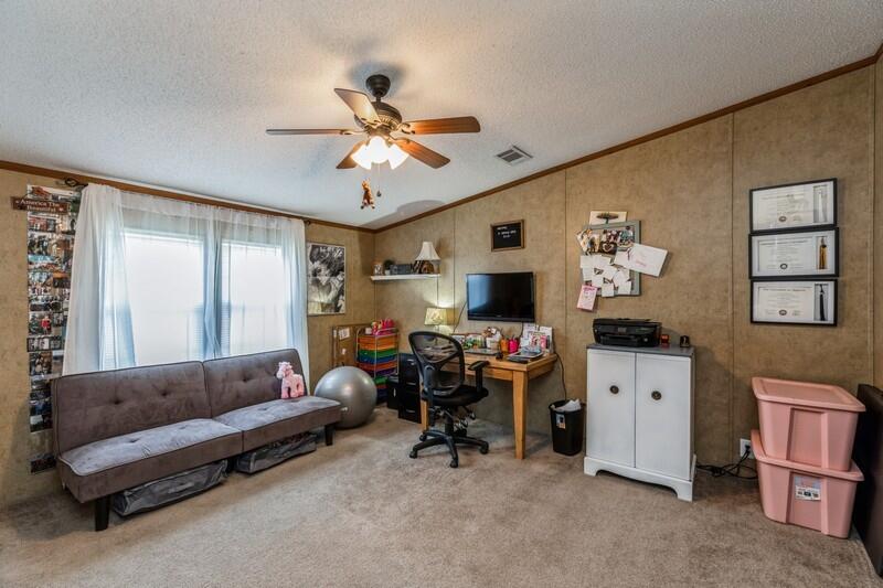 5995 Staff Road Crestview, FL 32536 - Photo 18 of 35 a living room with furniture and a flat screen tv