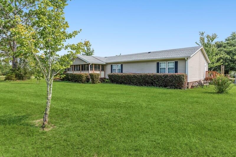 5995 Staff Road Crestview, FL 32536 - Photo 2 of 35 a view of house in front of a big yard with potted plants