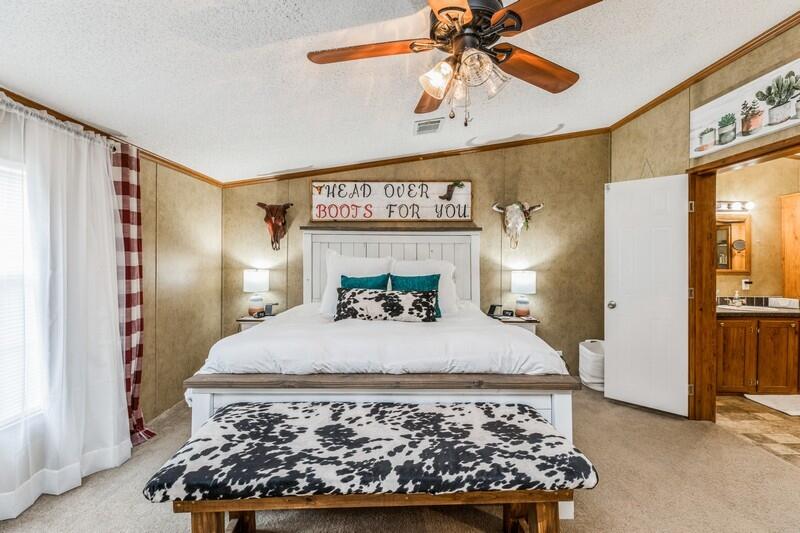 5995 Staff Road Crestview, FL 32536 - Photo 24 of 35 a bed sitting in a bedroom next to a window