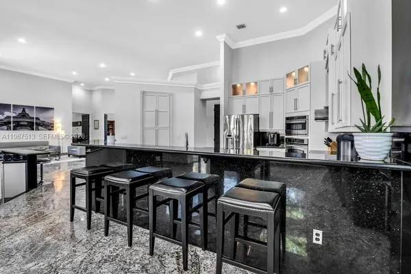 a living room with furniture a dining table and a large window