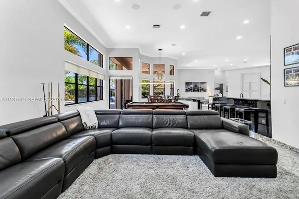 a living room with furniture and a large window