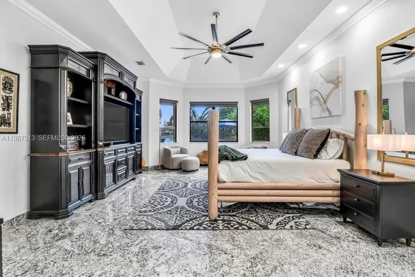 a bedroom with a bed couch and a large window