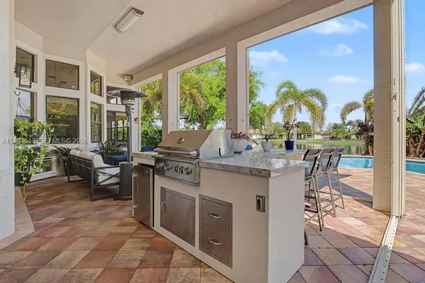 a very nice looking living room with a large window and dining table