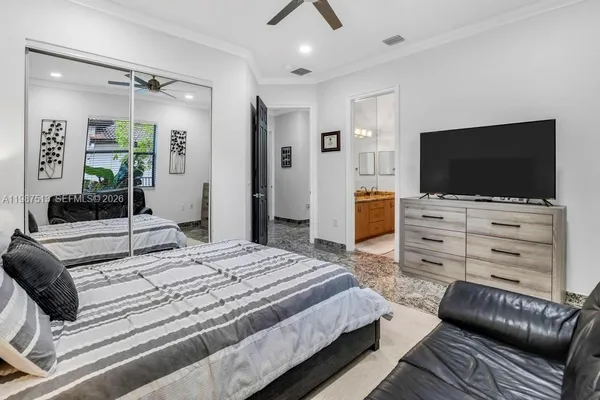 a bathroom with a granite countertop sink mirror vanity and toilet