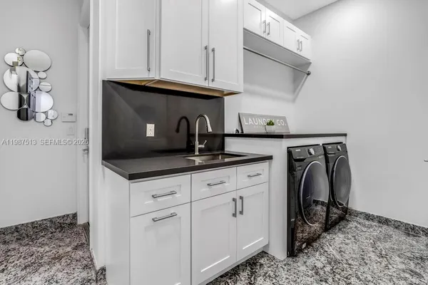 a view of a swimming pool with a table and chairs under an umbrella