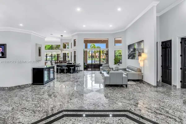 a living room with furniture and large windows