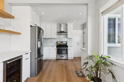 a kitchen with stainless steel appliances a refrigerator and a stove top oven