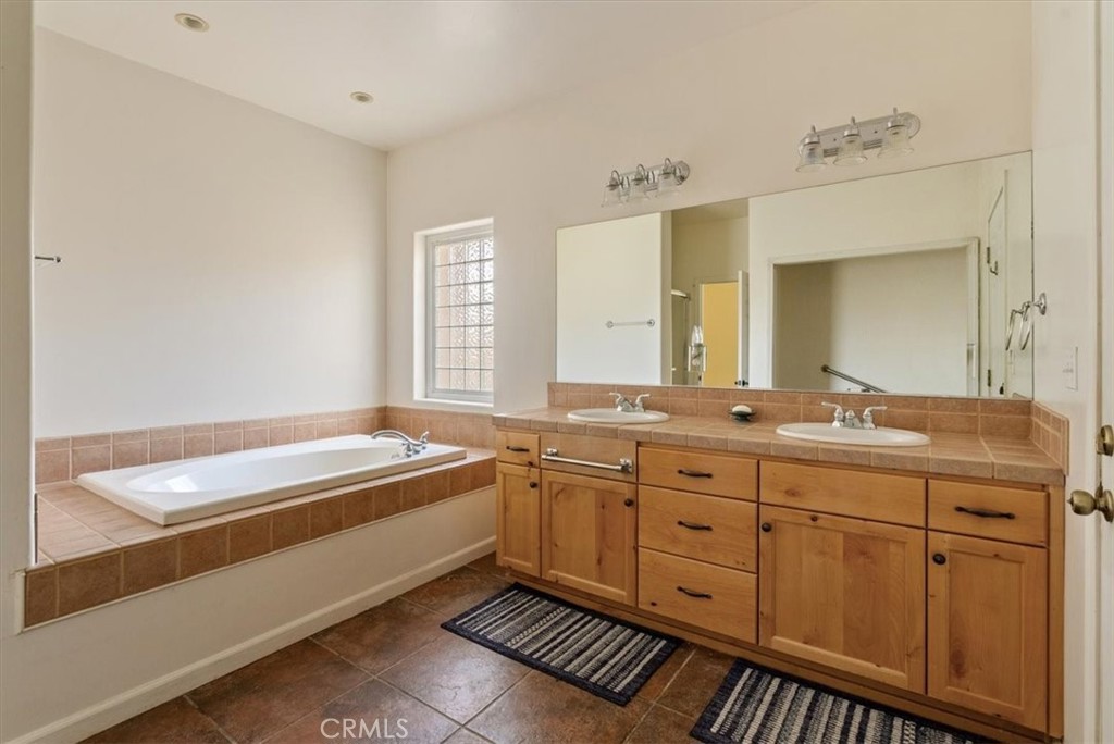 76846 Ranchita Canyon Road San Miguel, CA 93451 - Photo 24 of 51 a spacious bathroom with a granite countertop sink mirror and a bathtub
