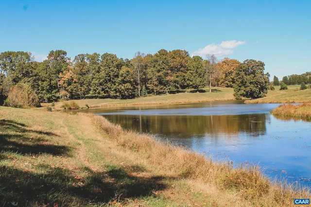 a view of a lake with houses in the back