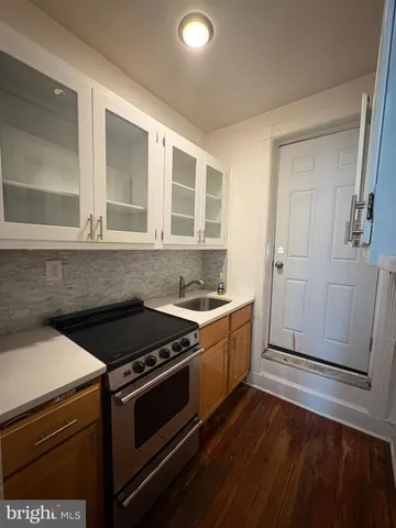 a kitchen that has a sink and a stove