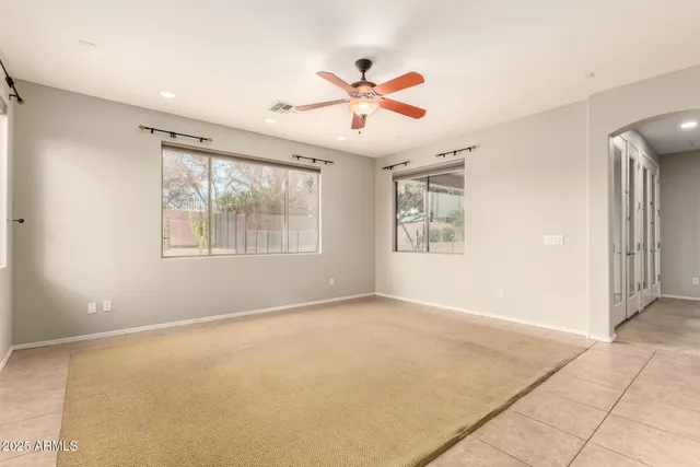 a large kitchen with stainless steel appliances kitchen island granite countertop a stove top oven a sink dishwasher and a refrigerator with wooden cabinets