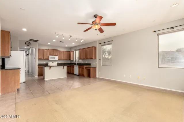 a kitchen with a sink stove top oven and cabinets