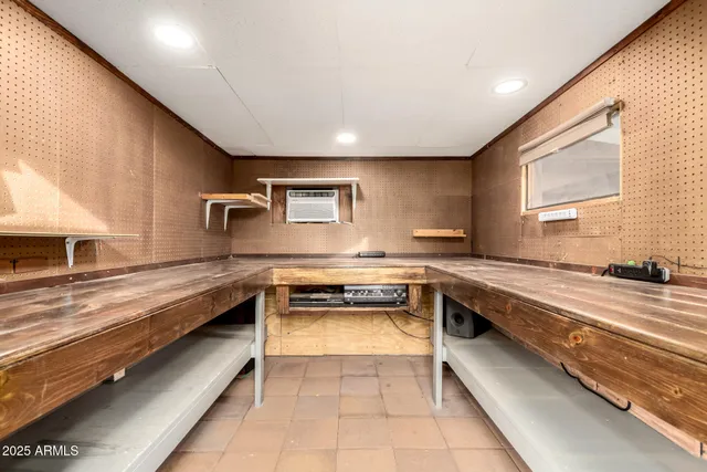 a view of a white house next to a yard with potted plants