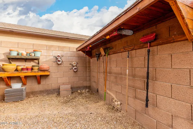 an aerial view of a house with a yard and wooden fence