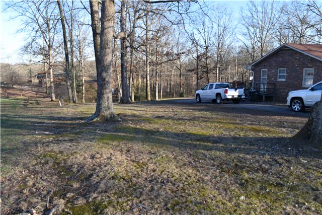 118 Robert Porter Road Dickson, TN 37055 - Photo 4 of 9 Lots of side yard. Property goes to the pvc pipes on the left and the telephone pole on the right. Circular Driveway.