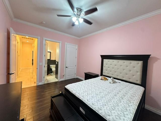 6830 North 14th Street Phoenix, AZ 85014 - Photo 25 of 28 a bedroom with a bed and wooden floor