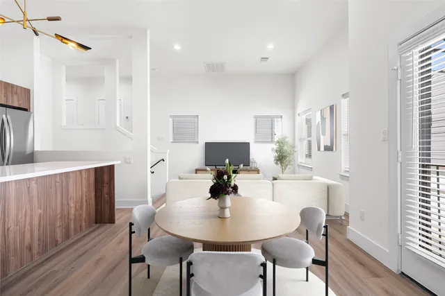 a view of a dining room with furniture and wooden floor