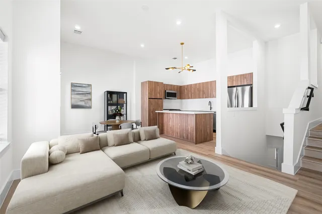 a living room with furniture and a wooden floor
