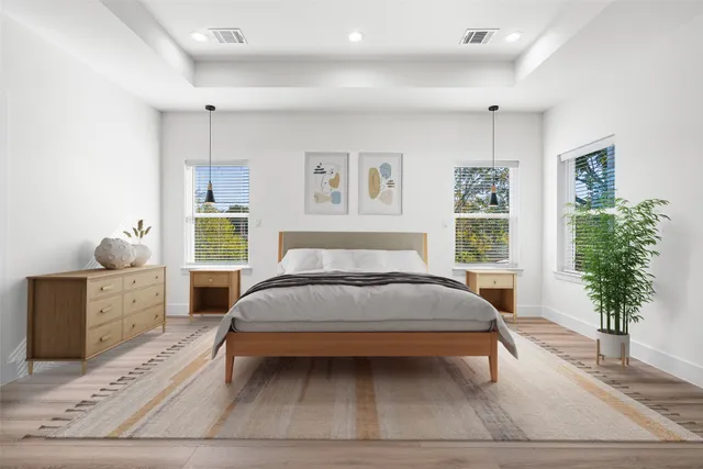 a bedroom with a large bed and a potted plant