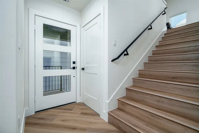 a view of entryway and hall with wooden floor