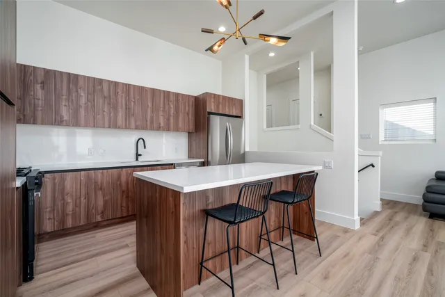 a kitchen with a sink cabinets and wooden floor